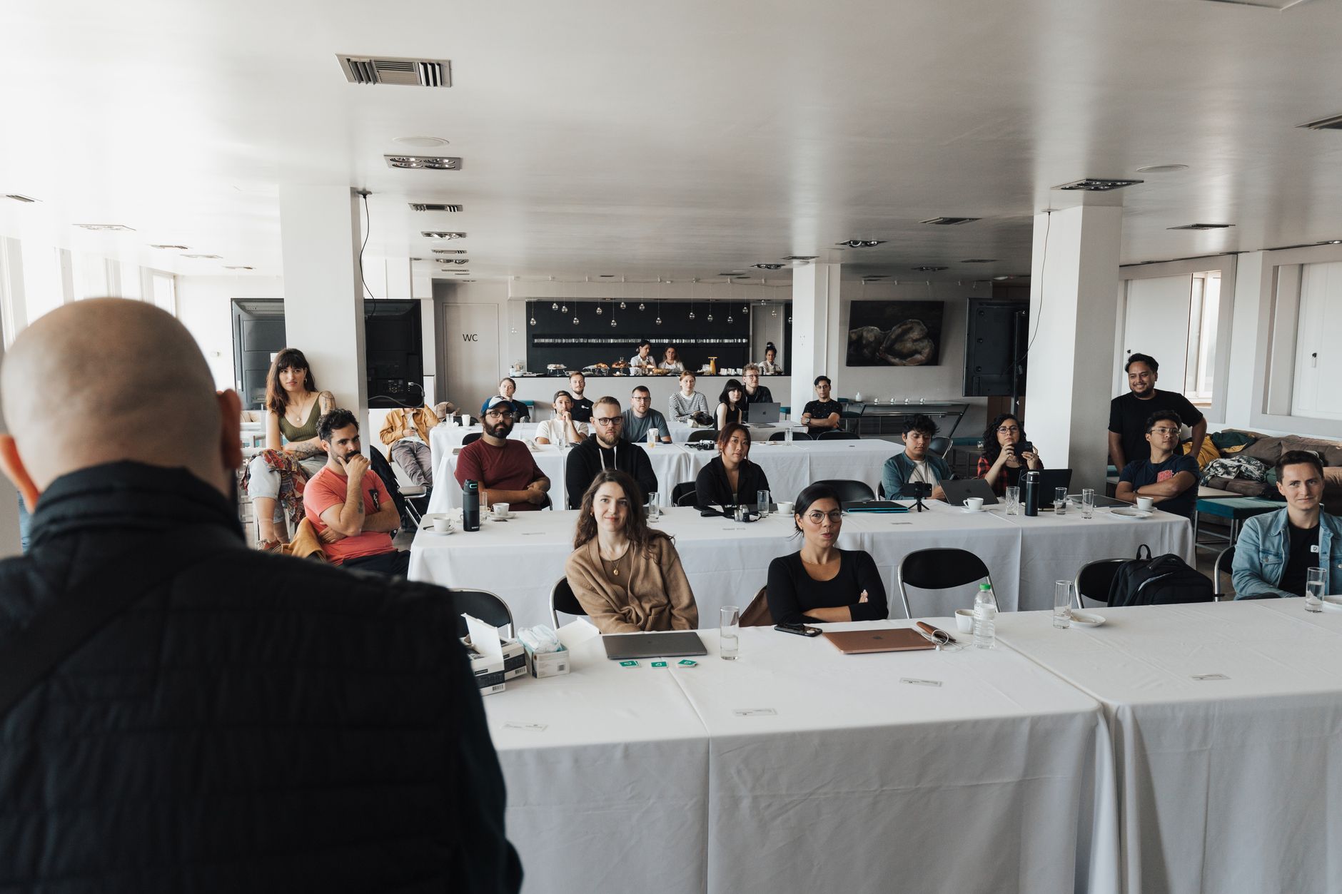 A diverse group of business professionals attending a presentation in a modern conference room.